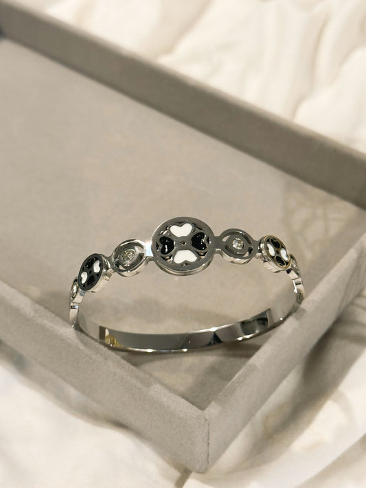 Four-leaf clover cuff with black and white heart motifs